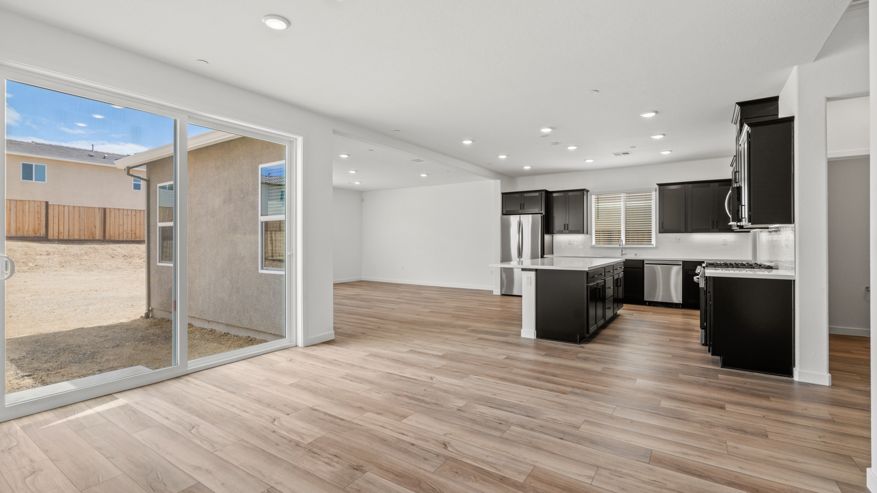 A large kitchen with a large glass wall.
