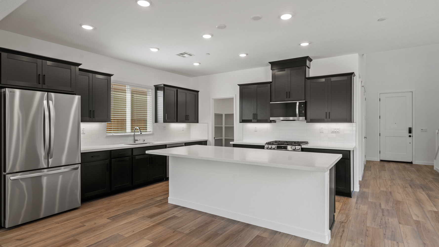 A kitchen with black cabinets.