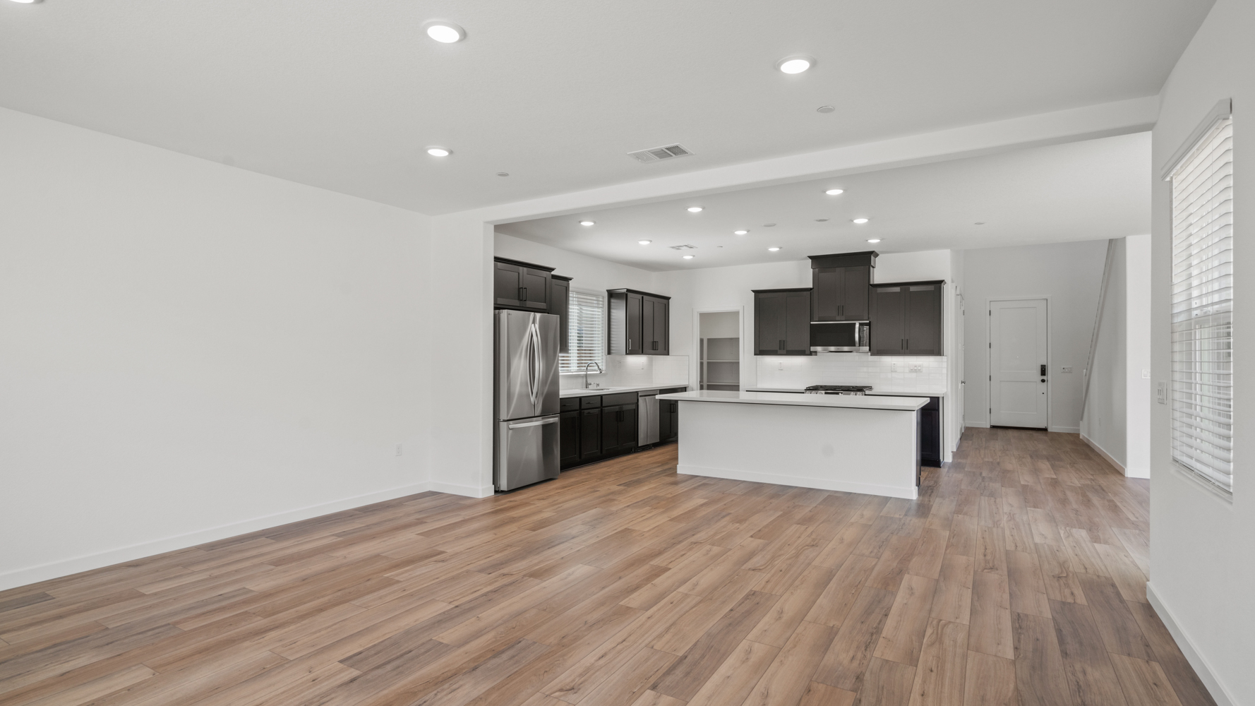 A kitchen with a wood floor.
