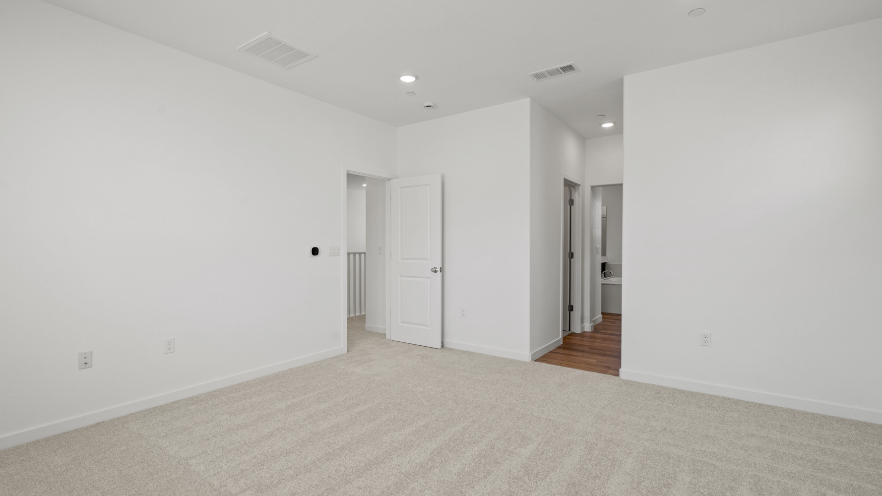 A hallway with white doors.