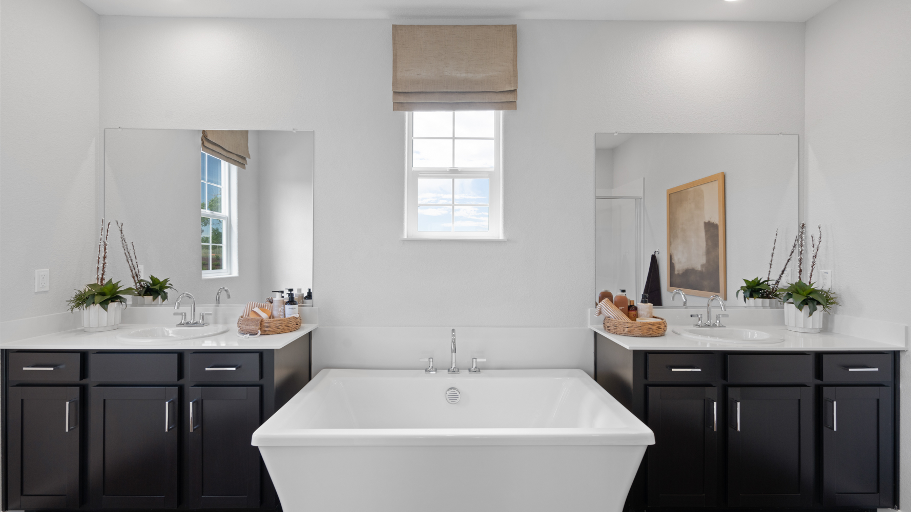 A bathroom with a tub sink and cabinets.