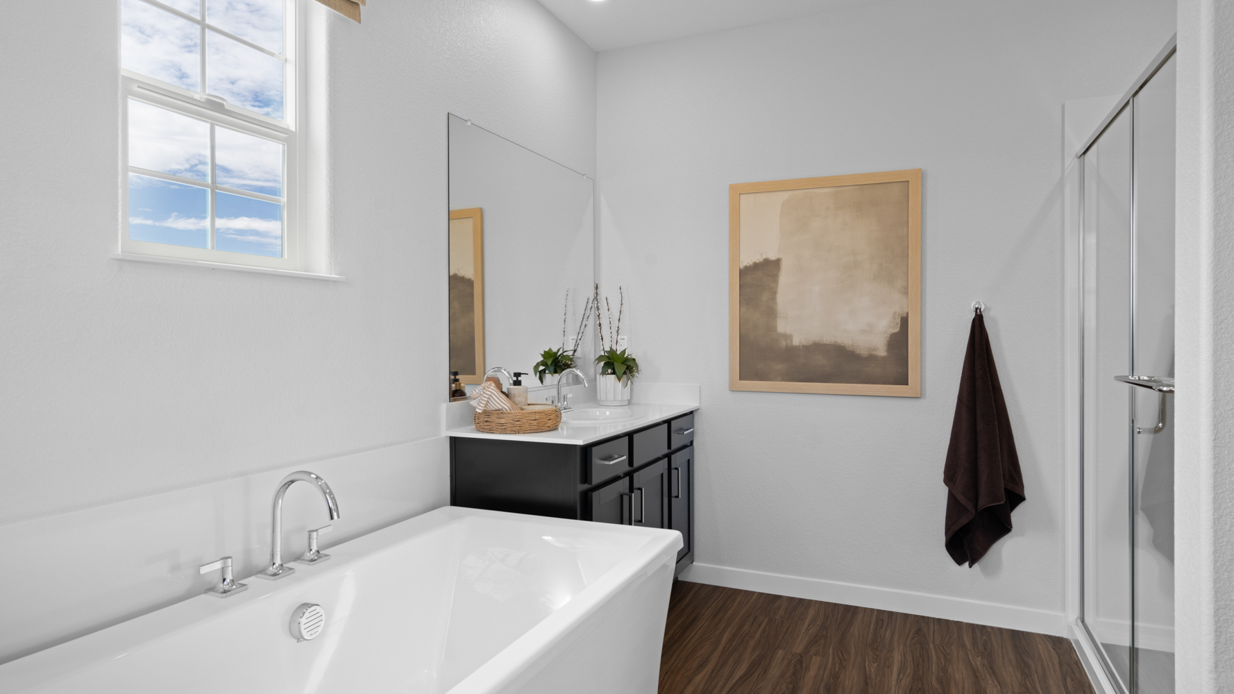 A bathroom with a tub sink and a mirror.