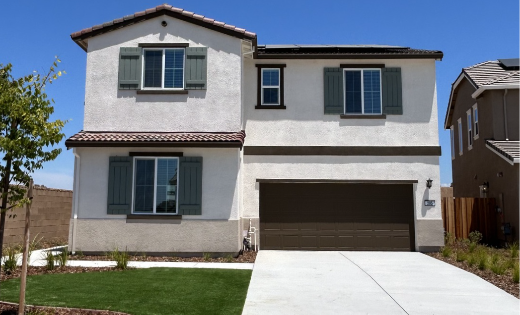 A white house with a garage.