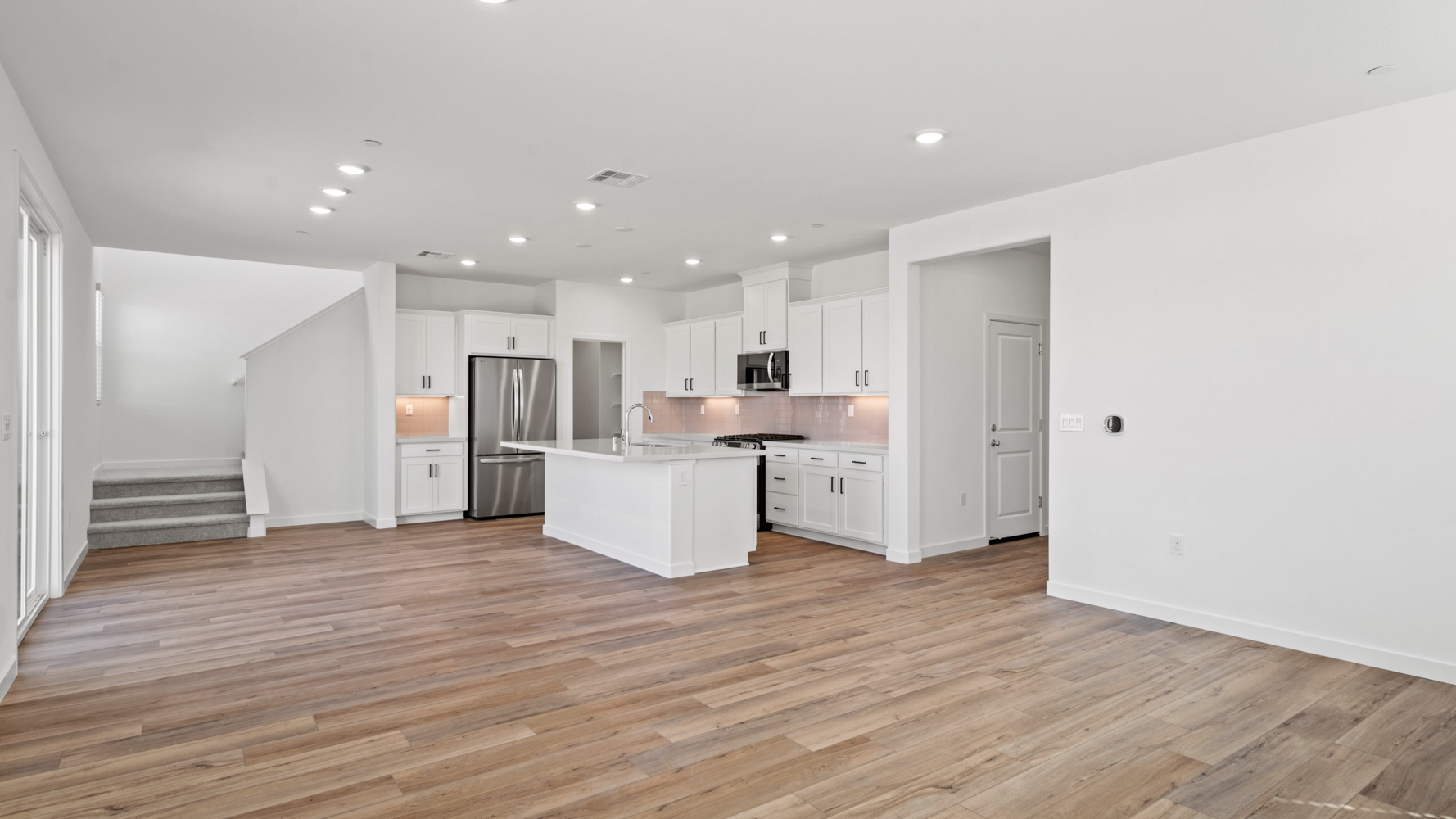 A large kitchen with white cabinets.