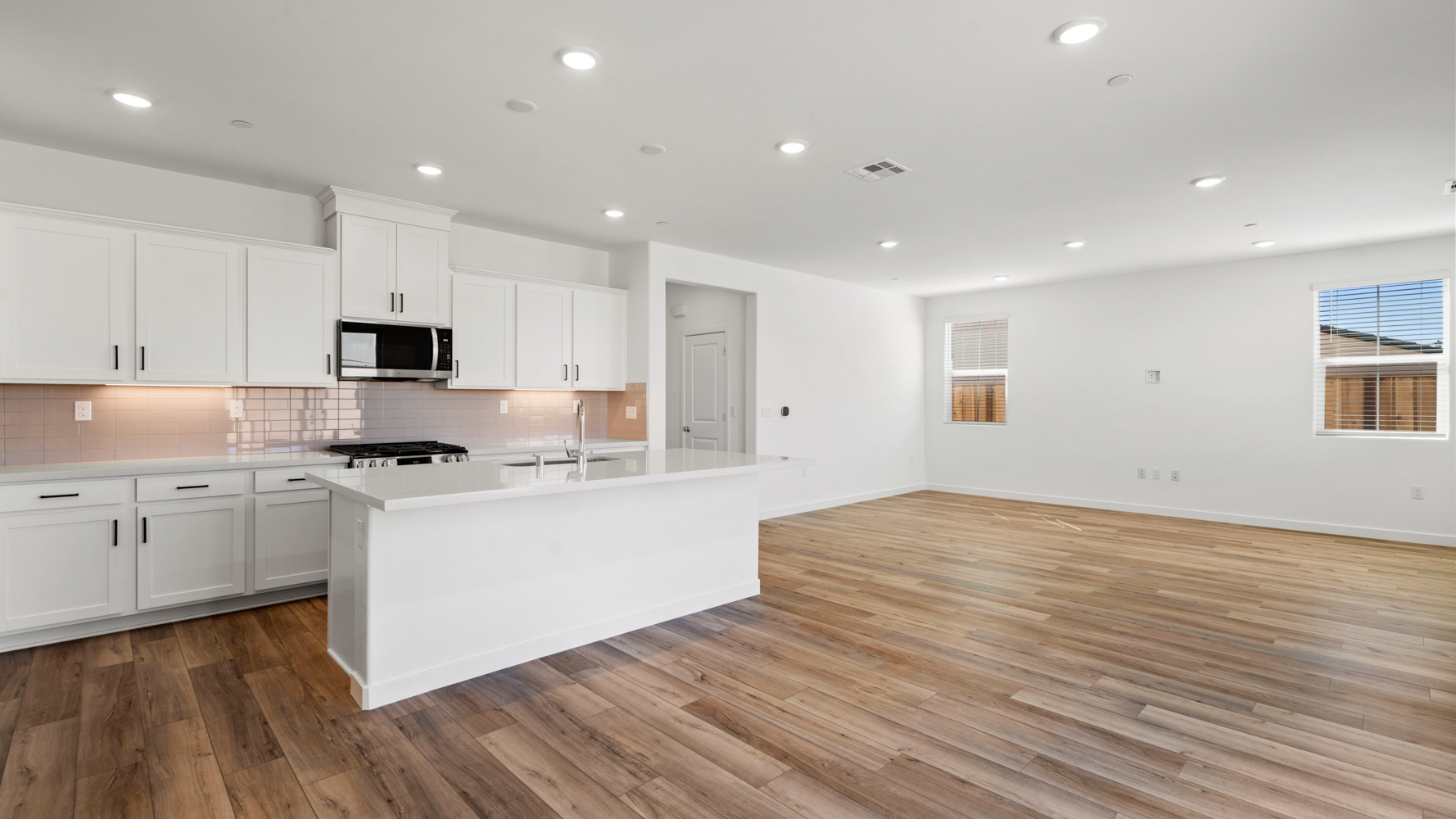 A kitchen with white cabinets.