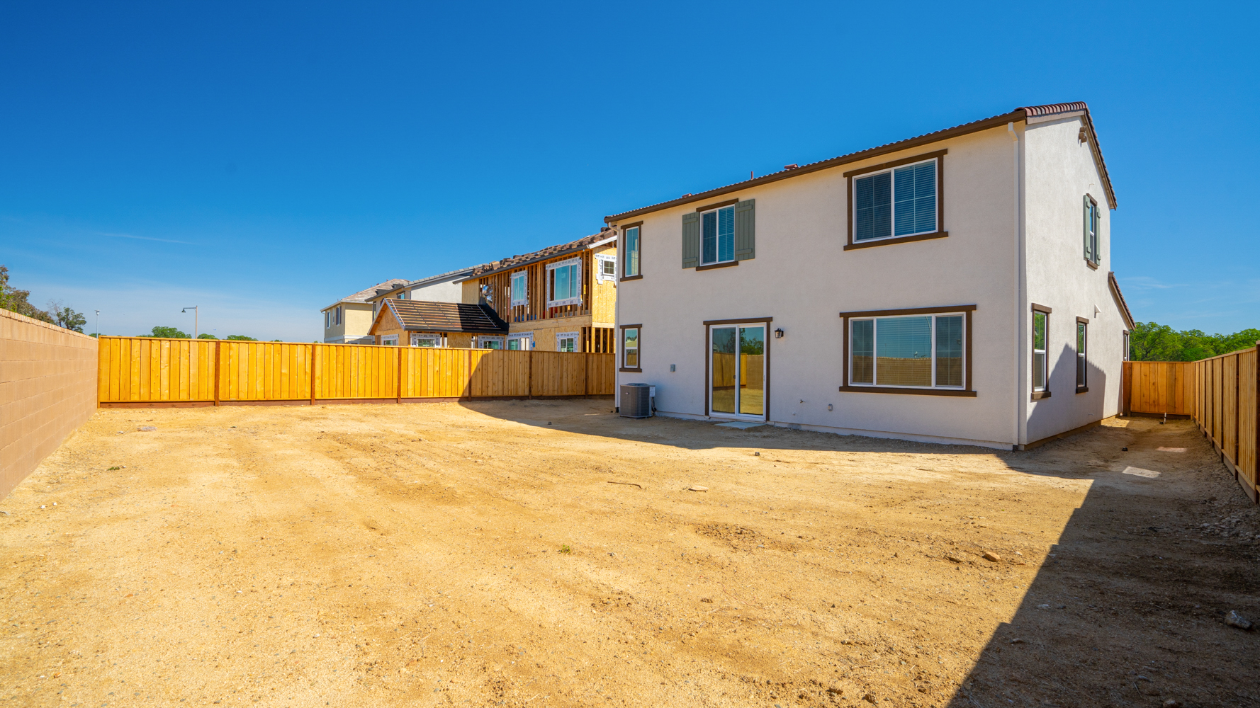 A house with a dirt yard.