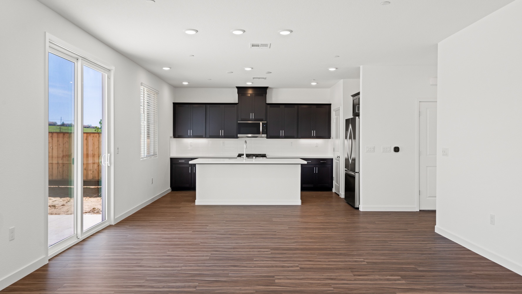 A kitchen with a wood floor.