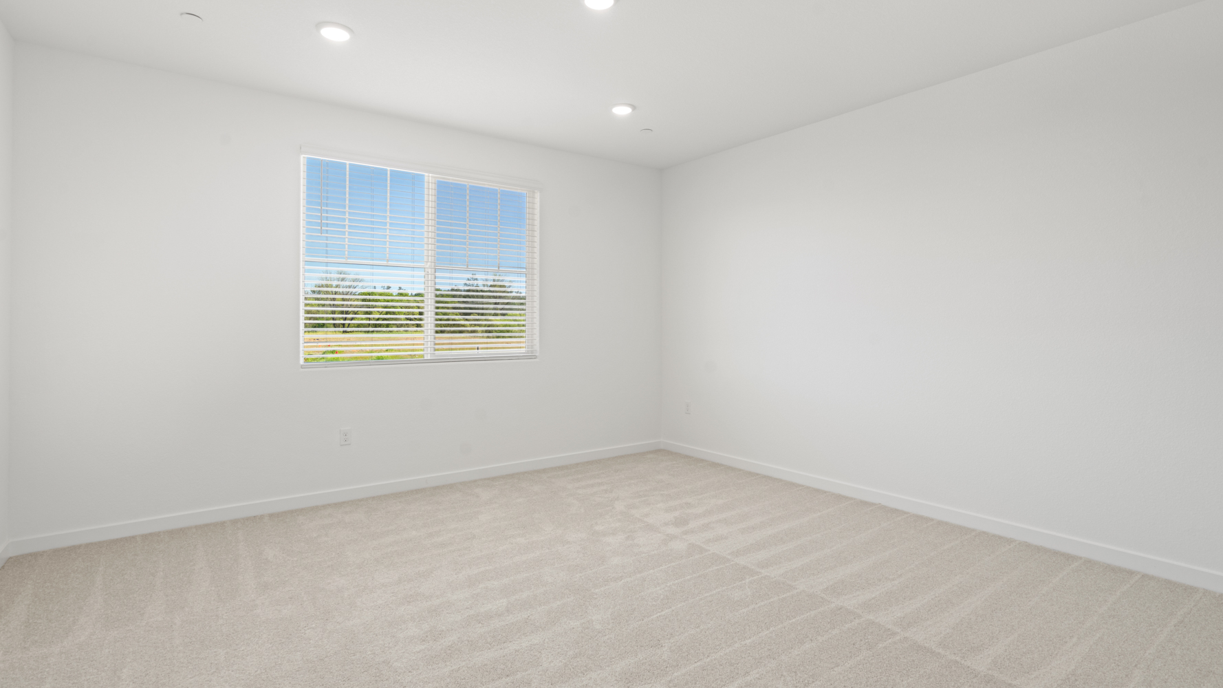 A room with a window and a tile floor.