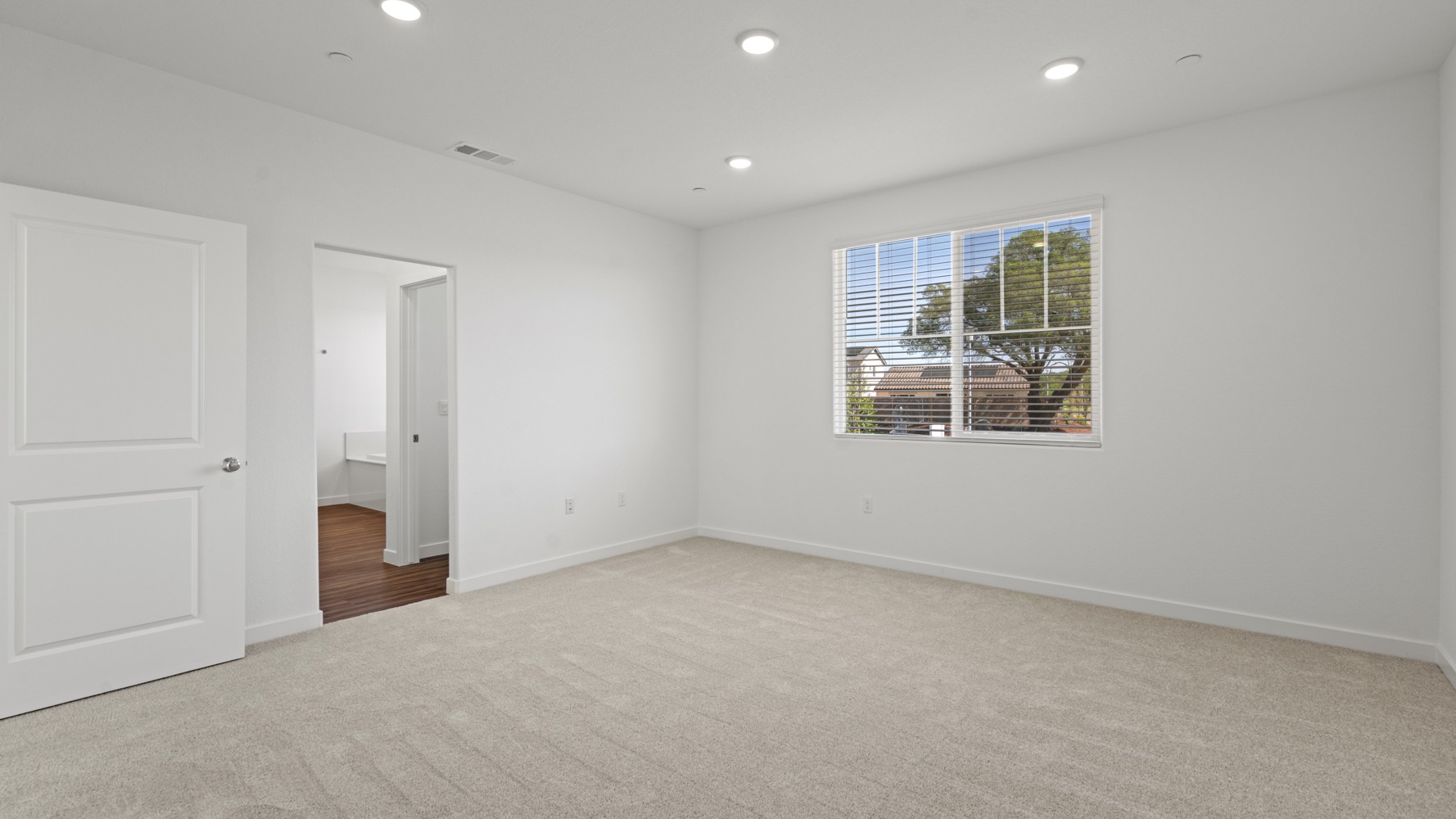 A room with white walls and a window.