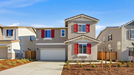 A white house with red shutters.
