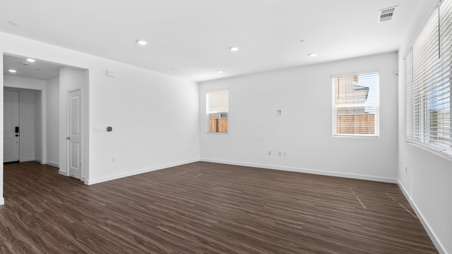 A room with a wood floor and white walls.