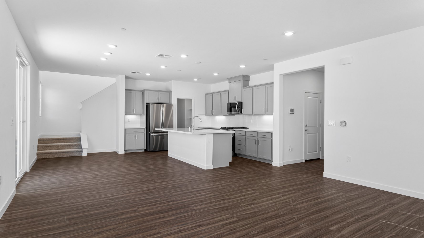 A large kitchen with white cabinets.