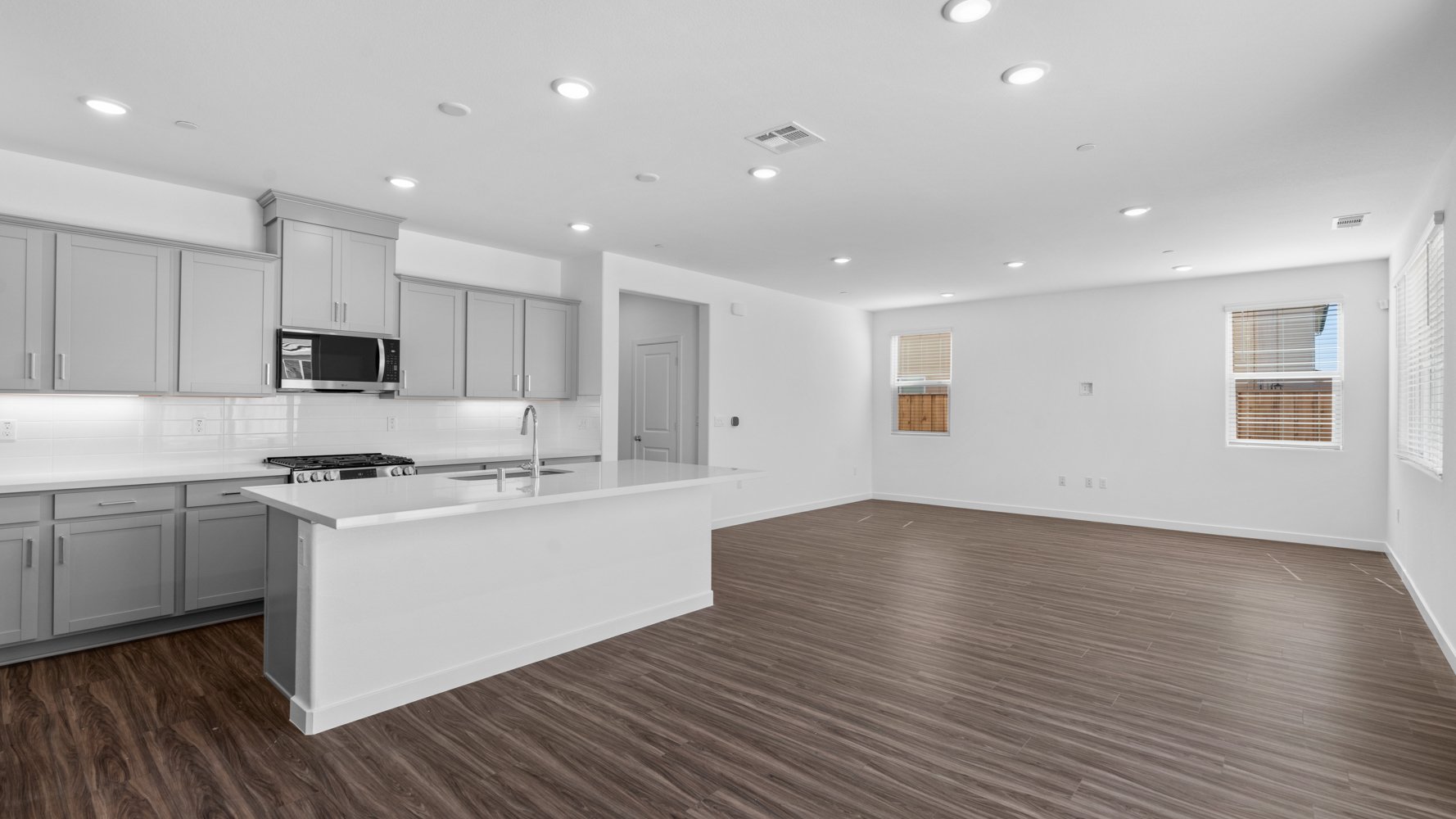 A kitchen with white cabinets.