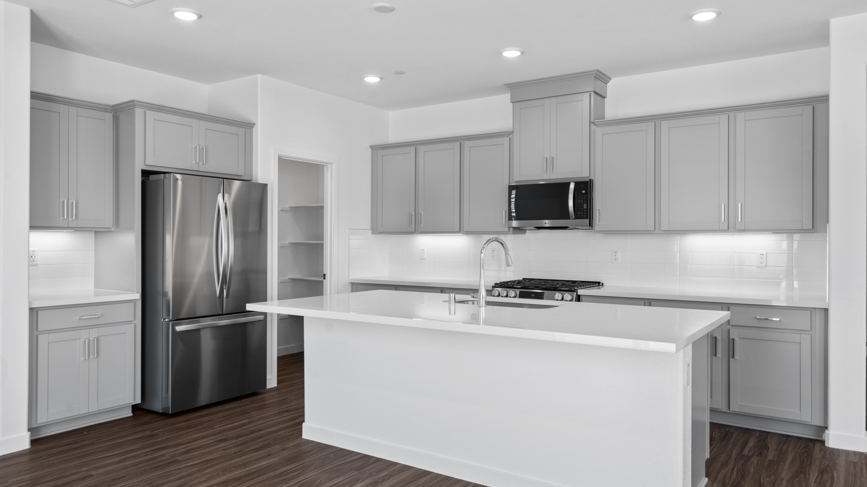 A kitchen with white cabinets.