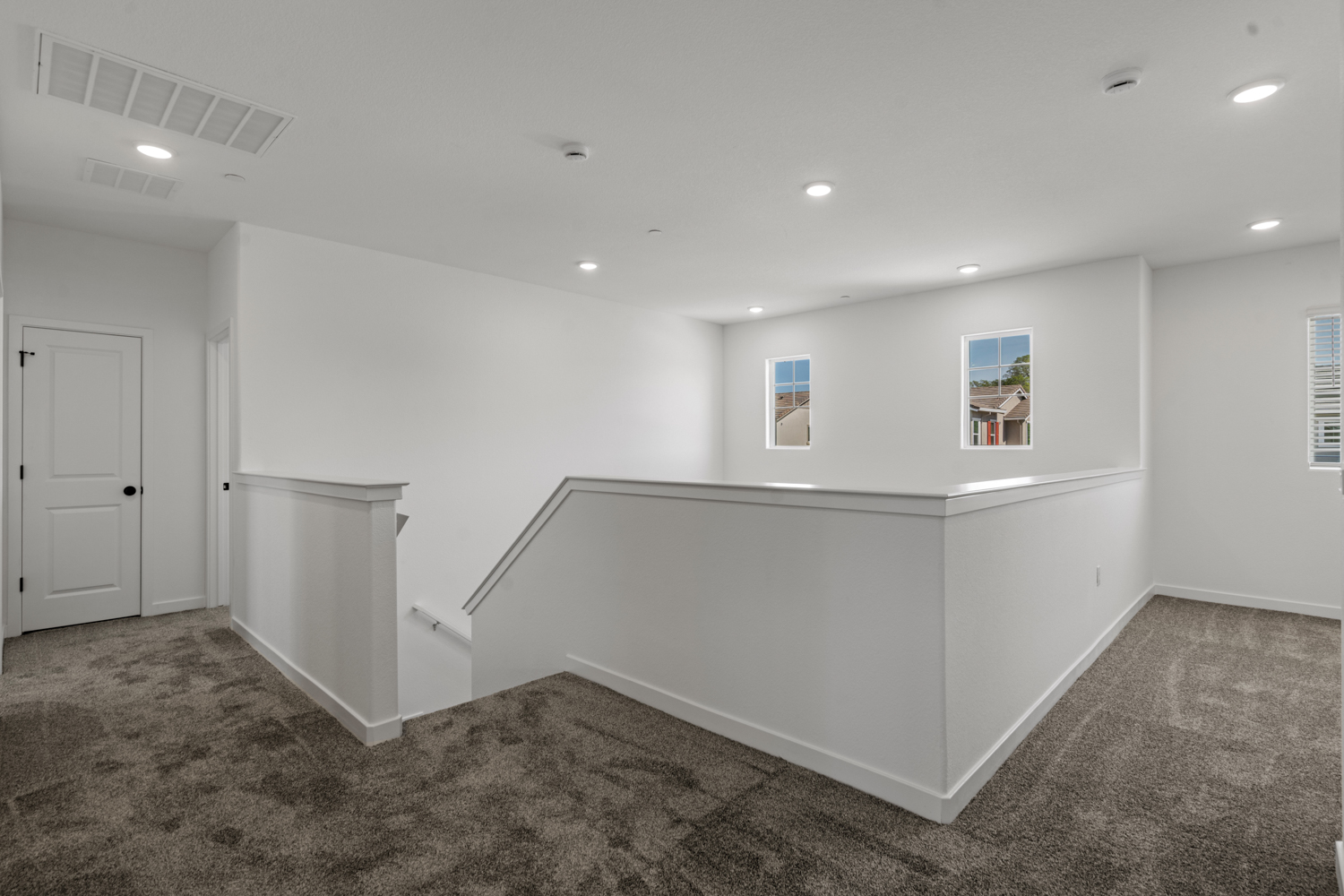 A white room with a white bench.