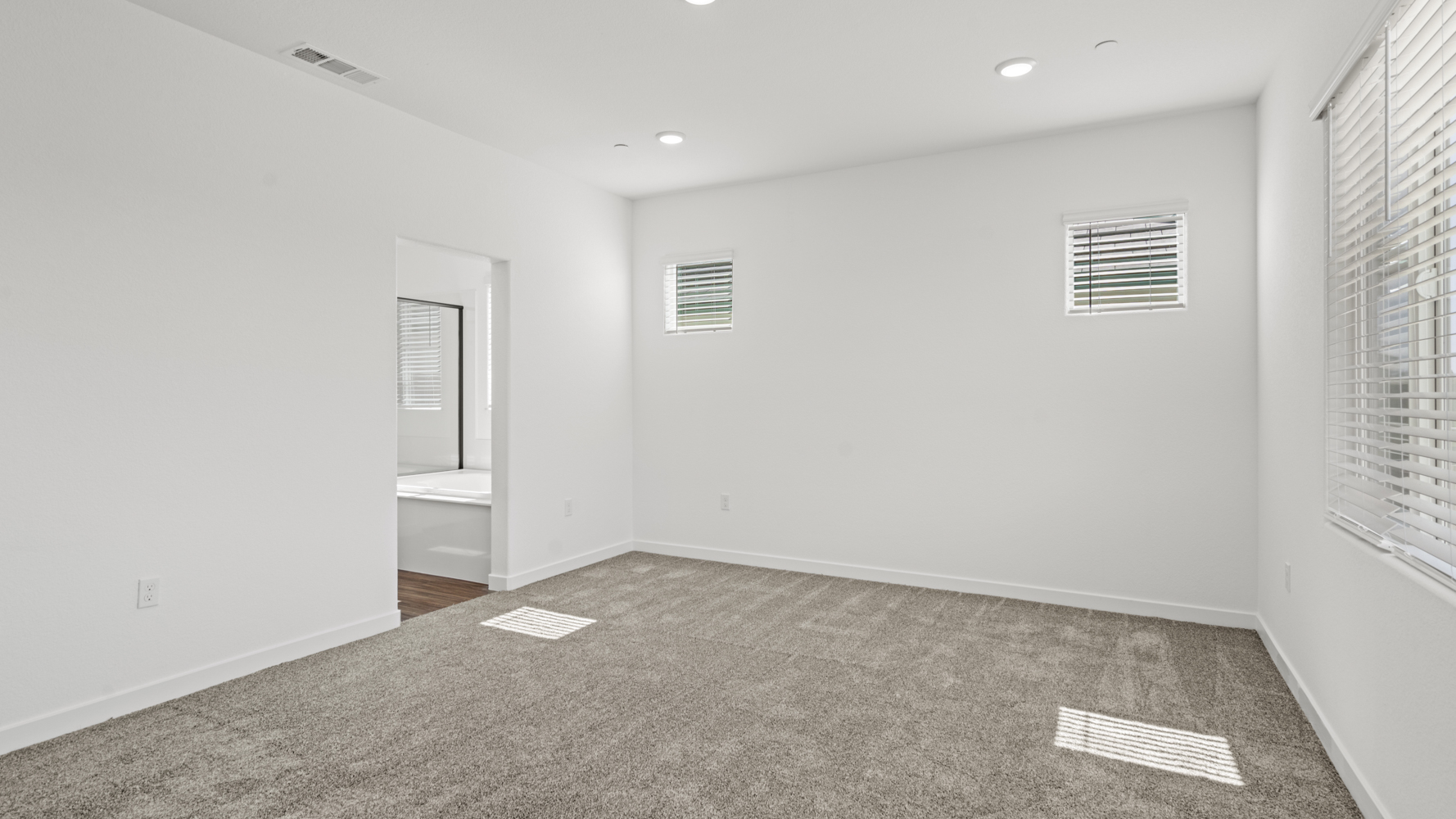 A room with a bed and a window.