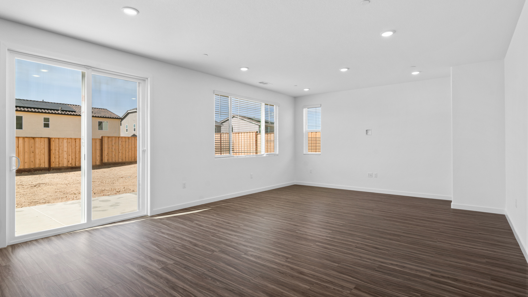 A room with a wood floor and a wood floor with a glass door.