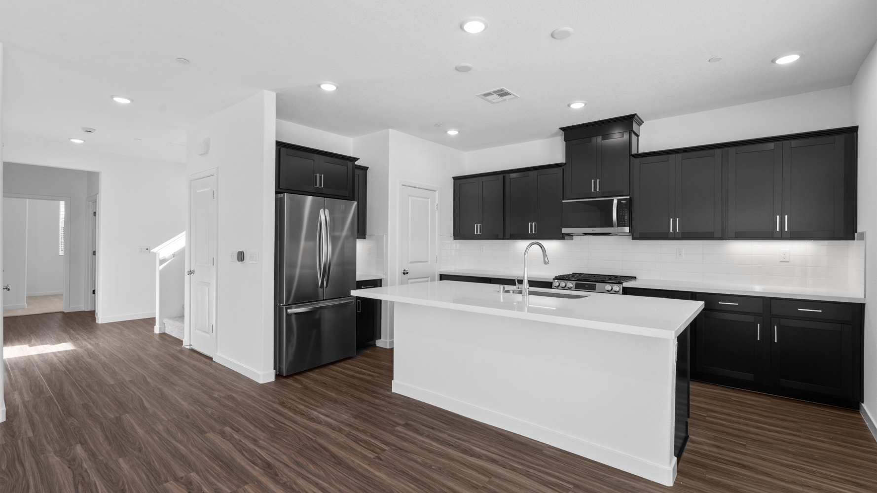 A kitchen with black cabinets.