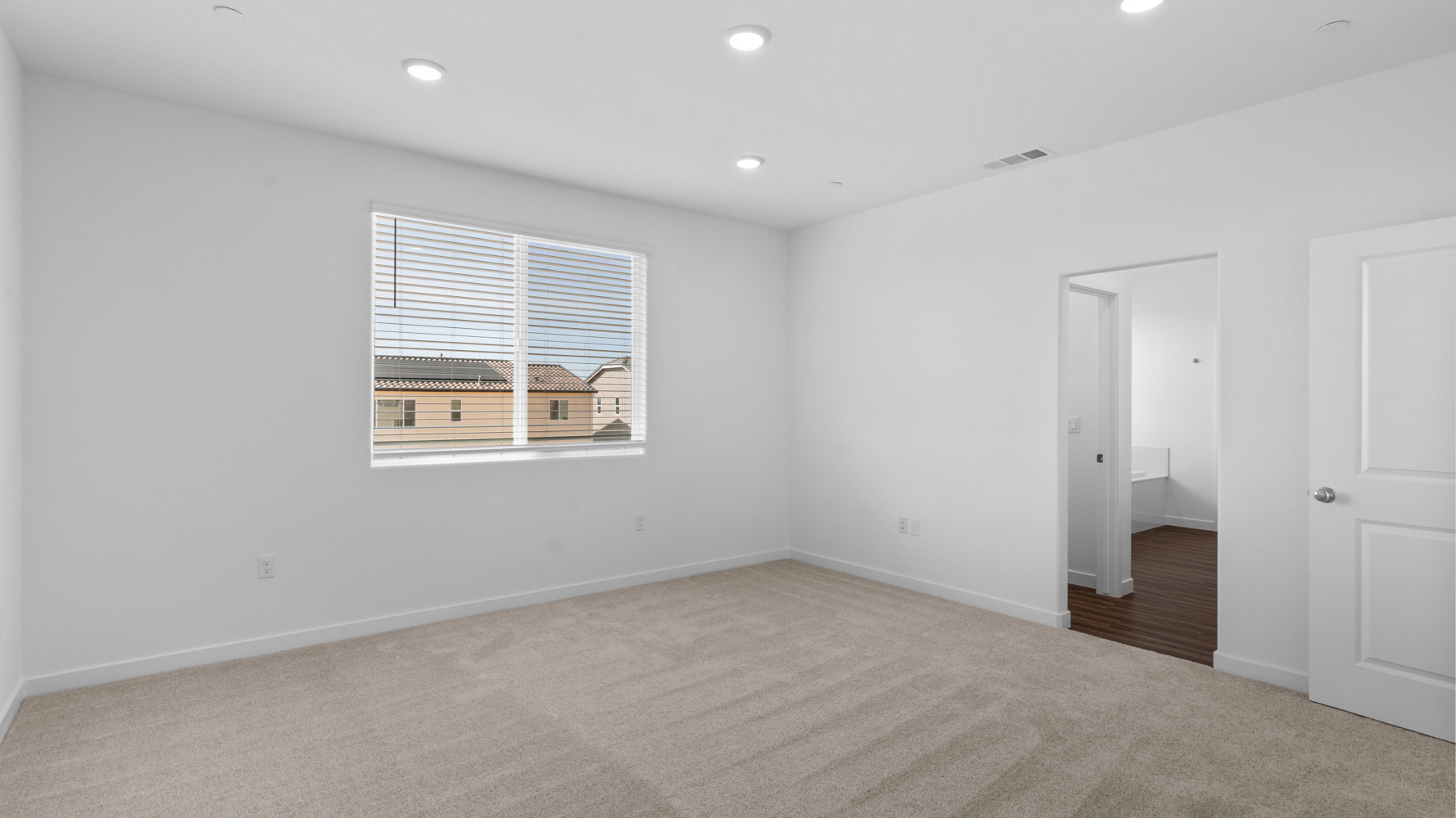A room with white walls and a window.