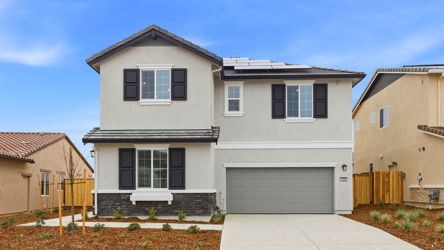 A white house with a garage.