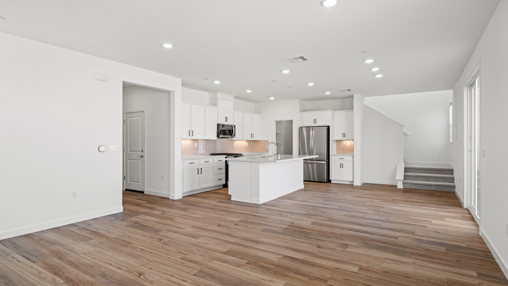 A large kitchen with white walls.