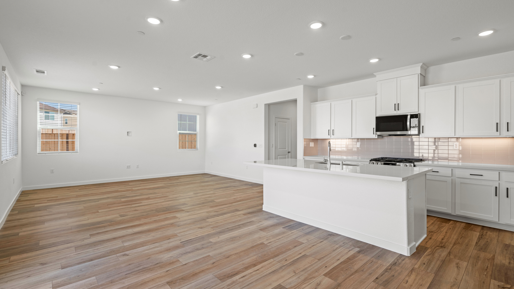A kitchen with white cabinets.