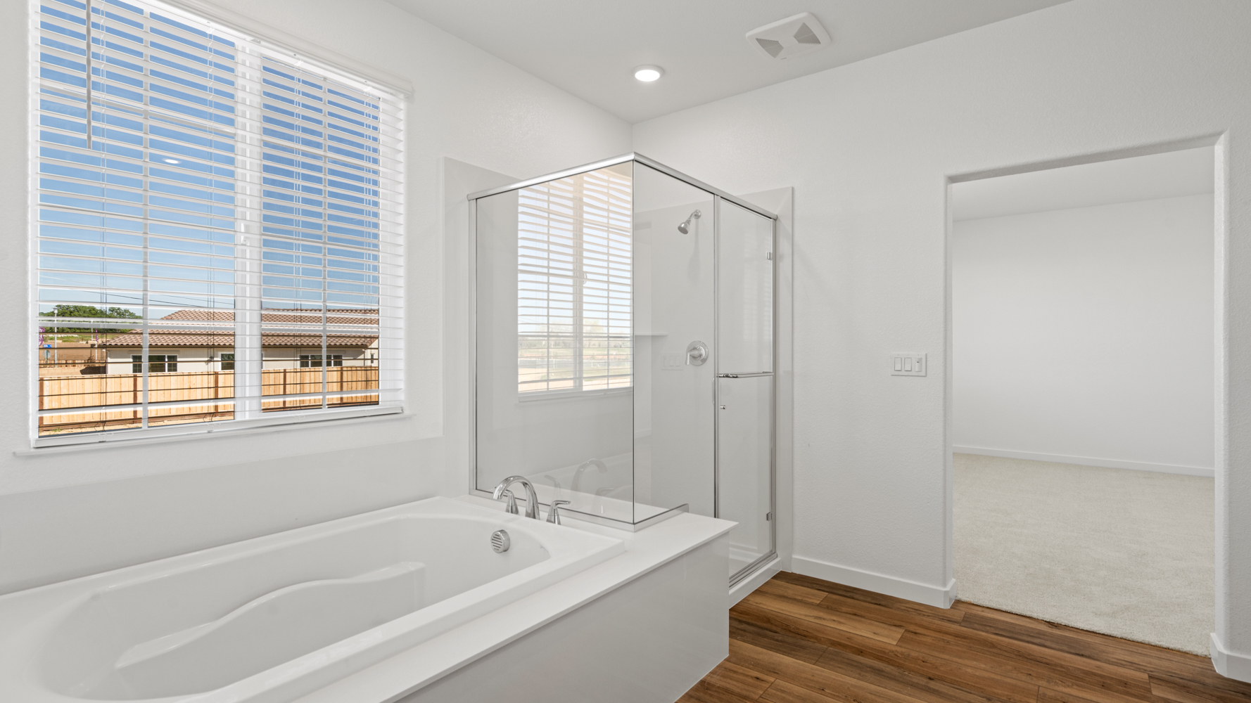A bathroom with a tub and a window.