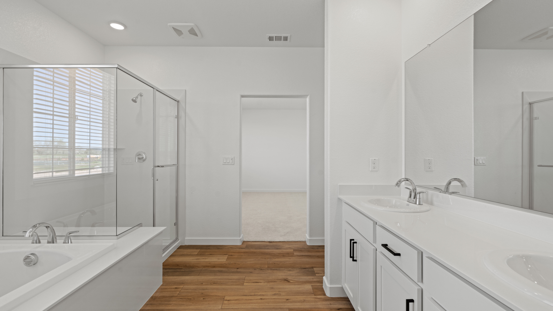 A bathroom with white cabinets.
