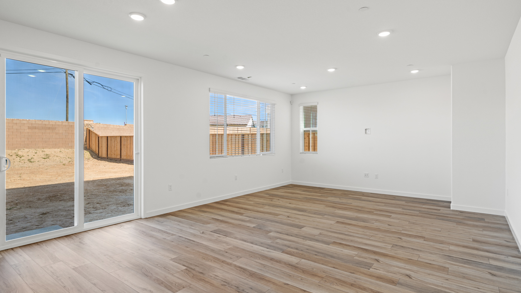 A room with a wood floor and a wood floor with a window.