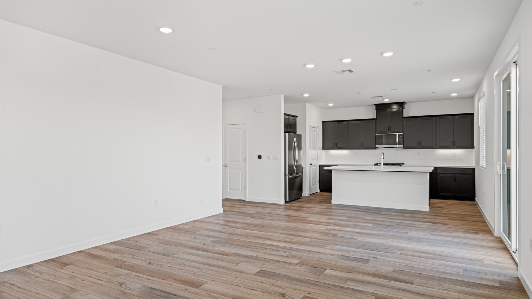 A kitchen with black cabinets.