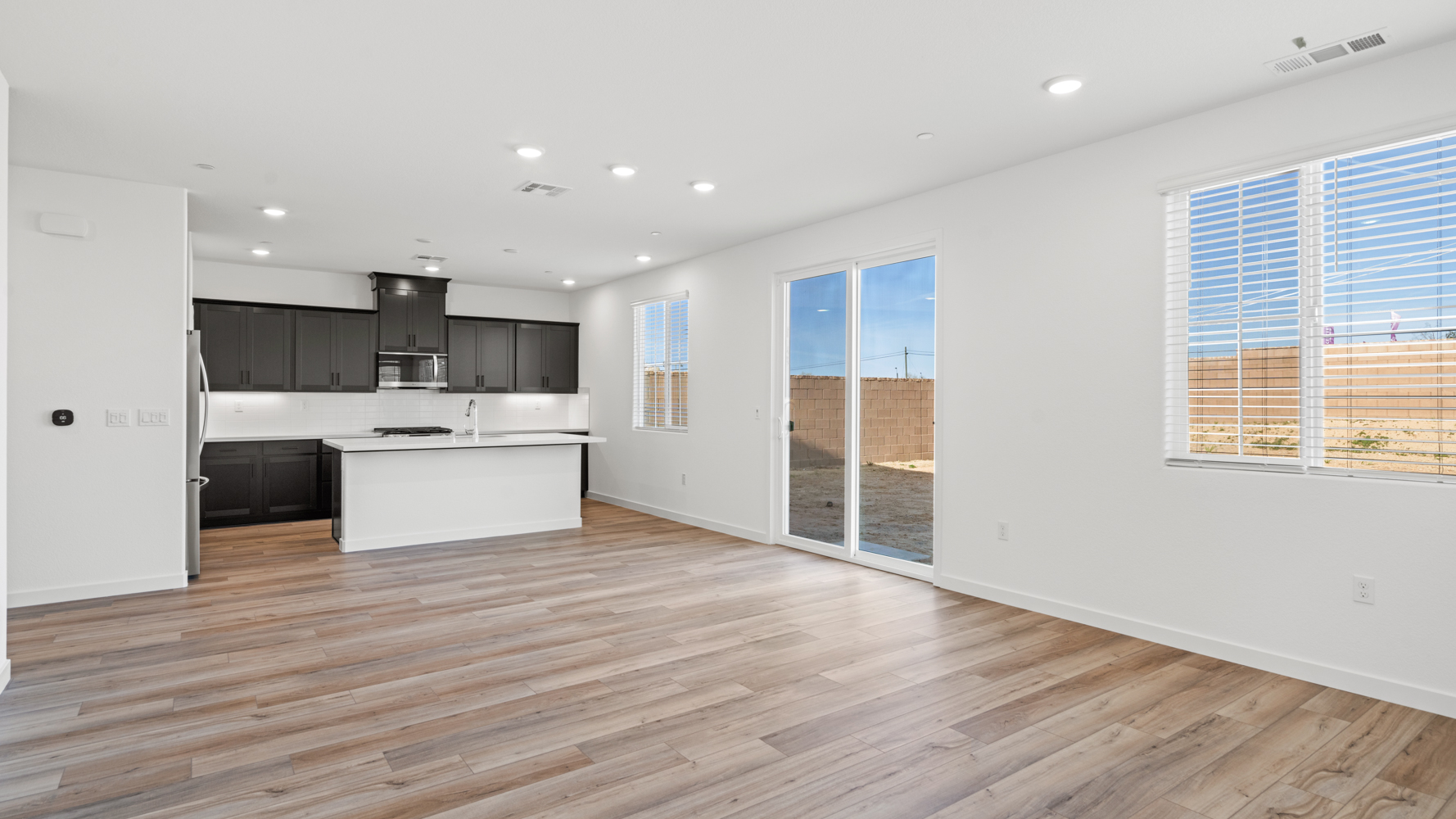 A kitchen with a wood floor.