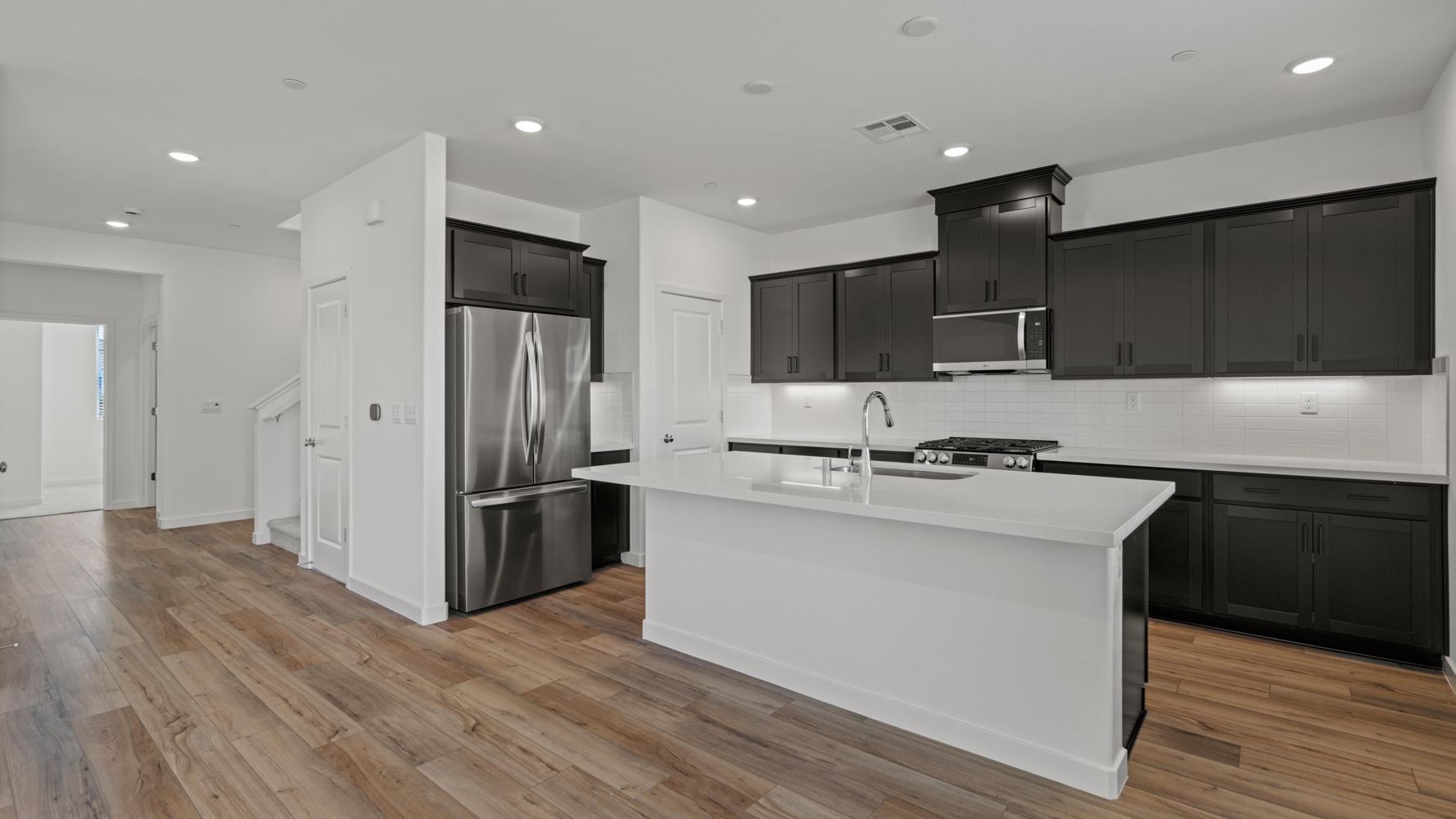 A kitchen with black cabinets.
