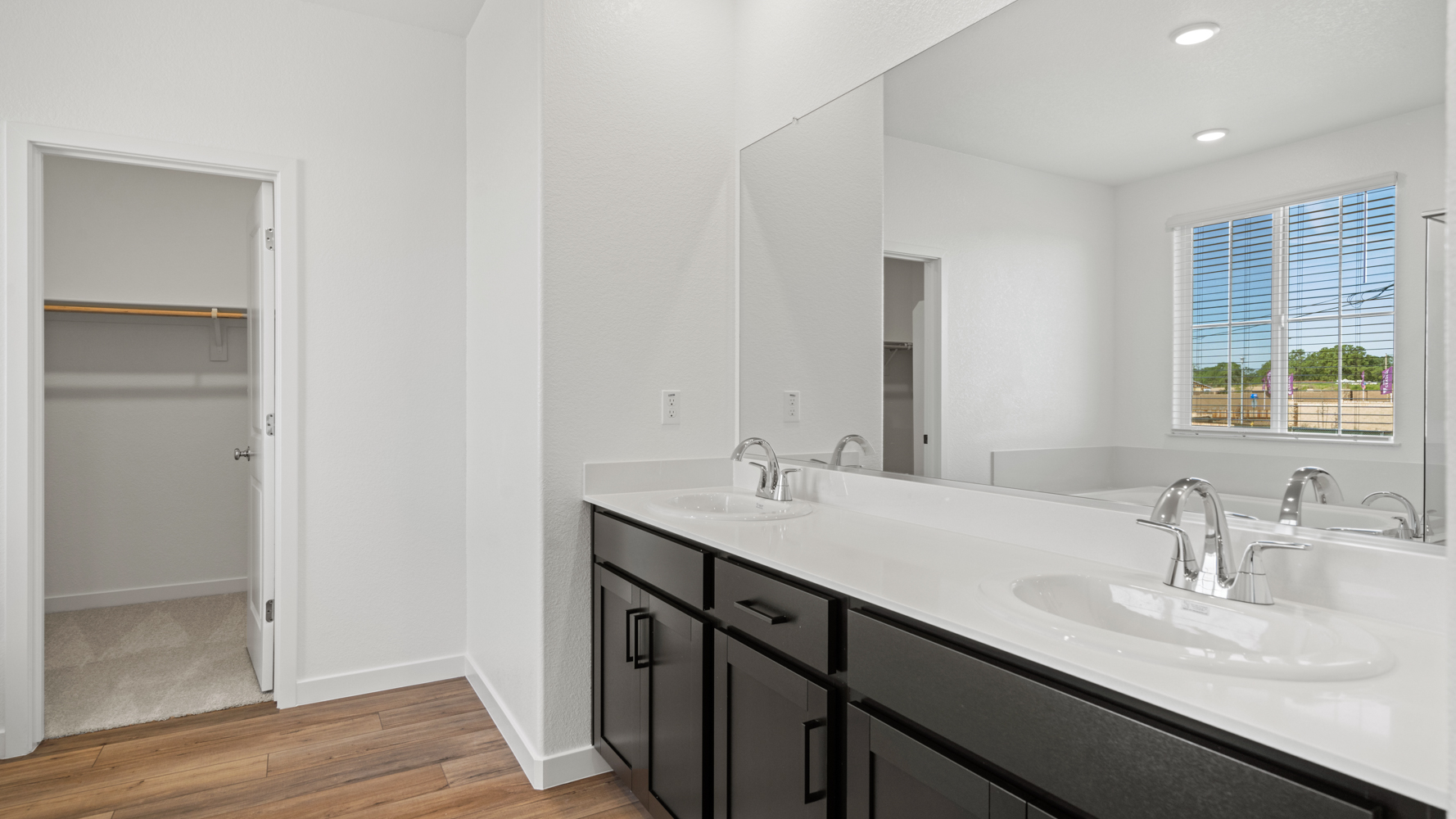 A bathroom with a large mirror.