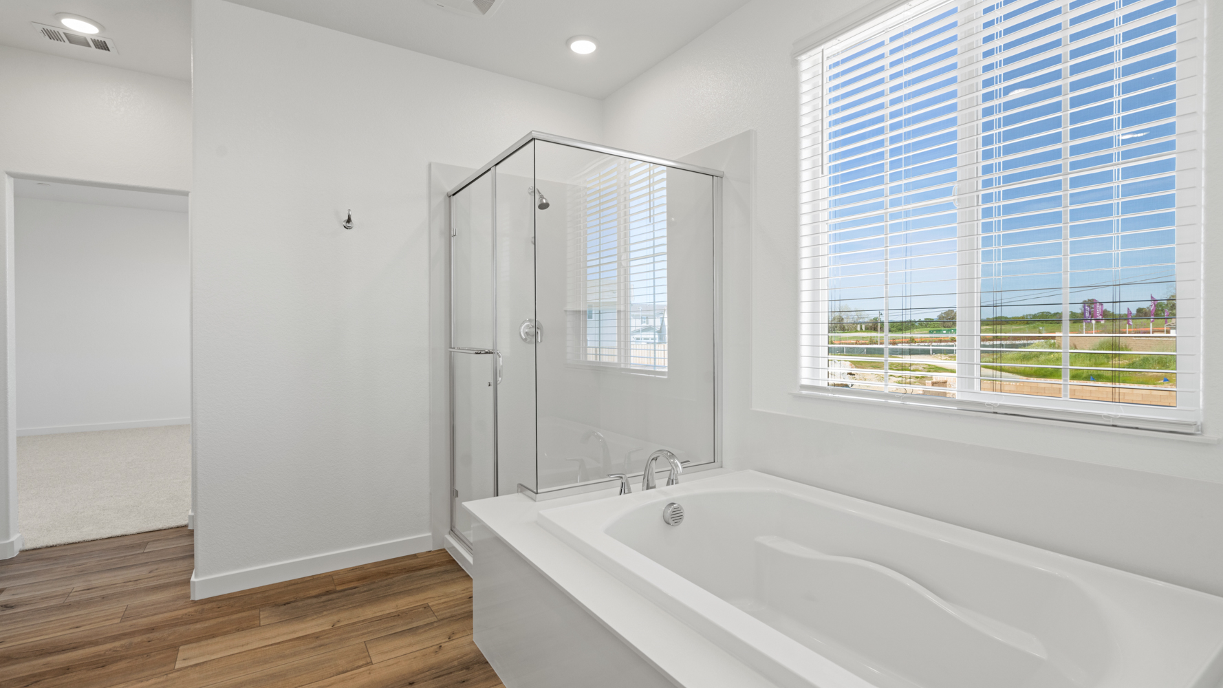 A bathroom with a tub and a window.