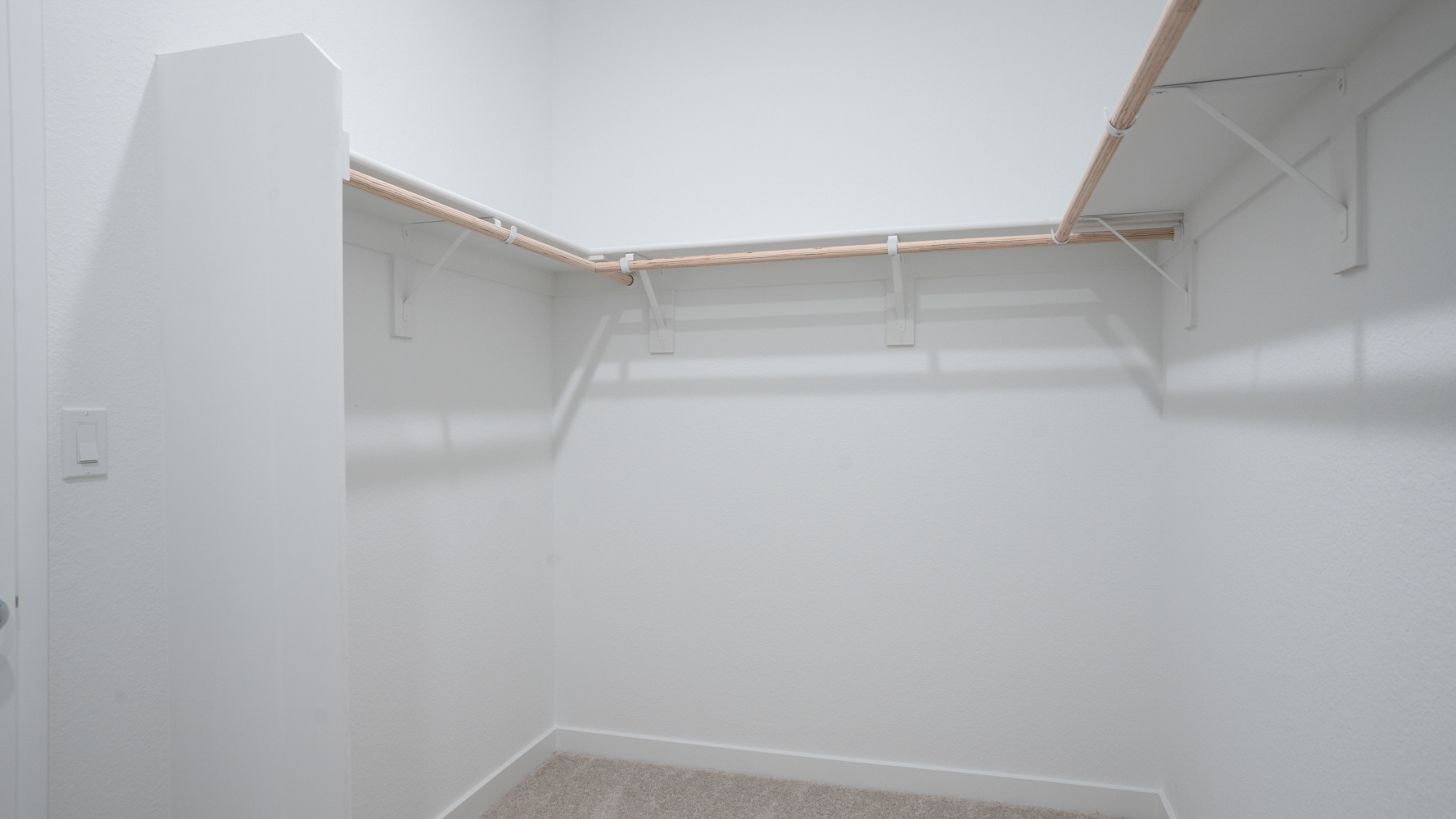 A white wall with a metal ladder.