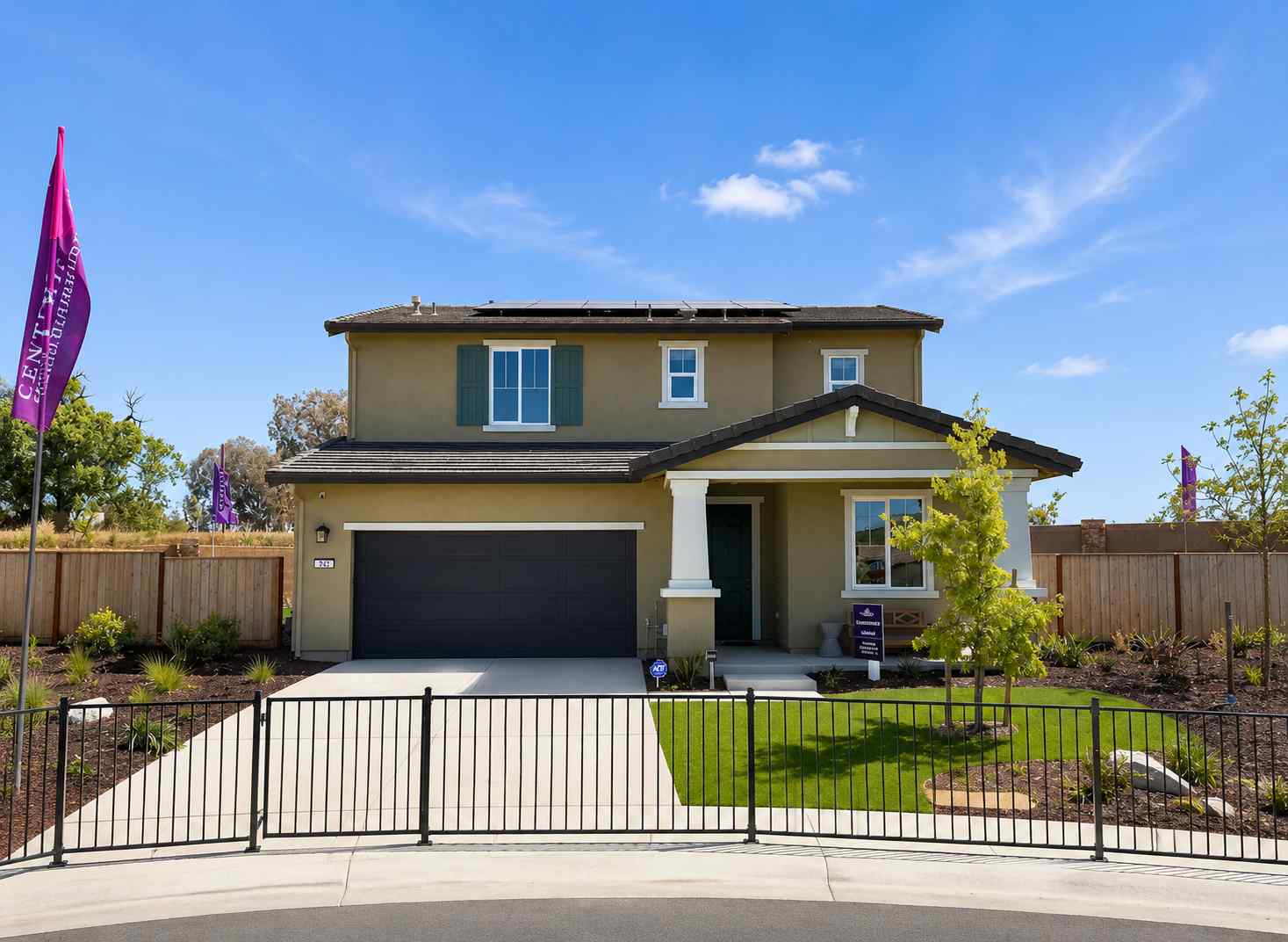 A house with a fence and a gate in front of it.