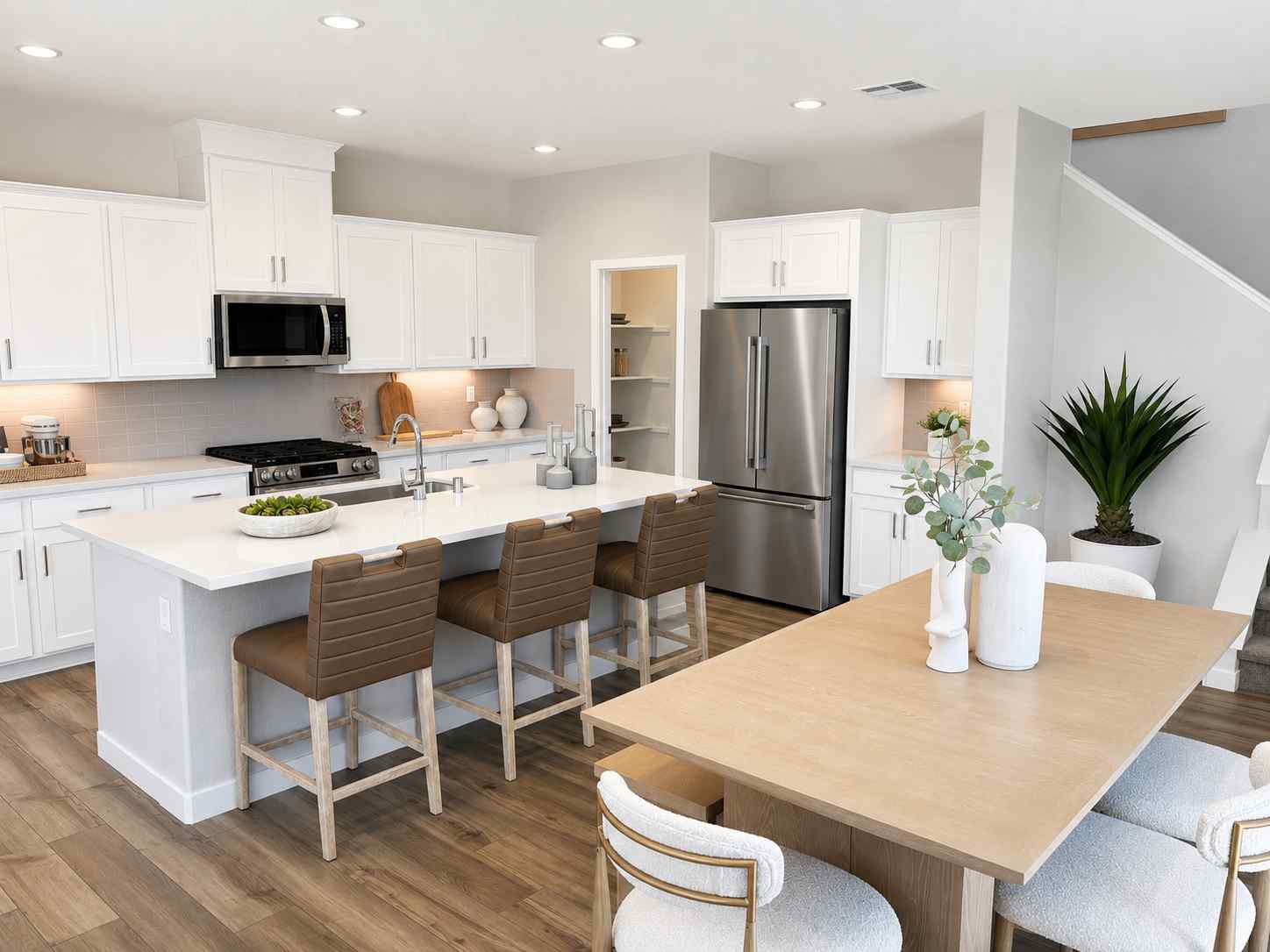 A kitchen with white cabinets.