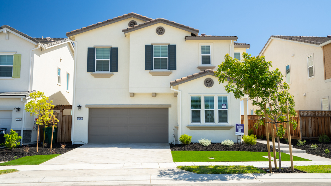 A white house with a garage.