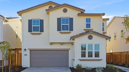 A yellow house with a garage.