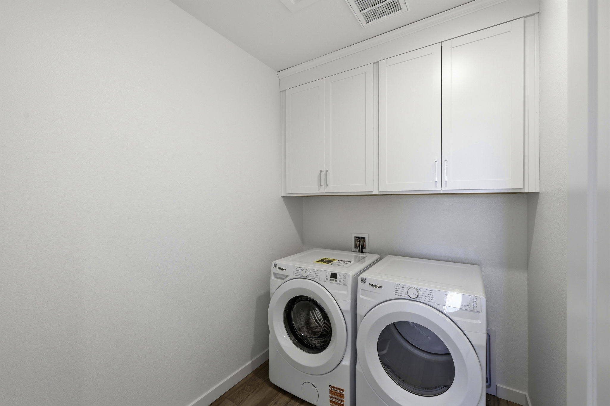 A washing machine and dryer in a room.