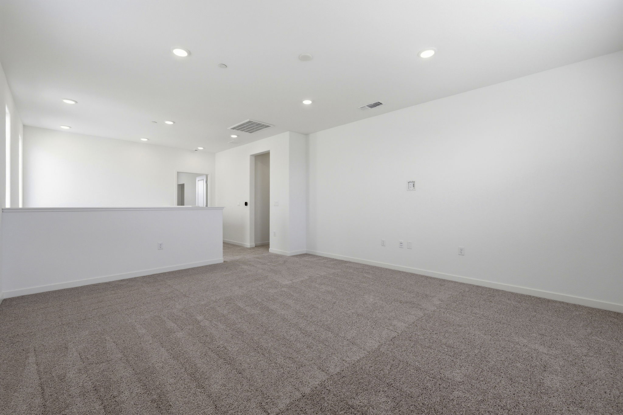 A room with a carpet and a carpet.