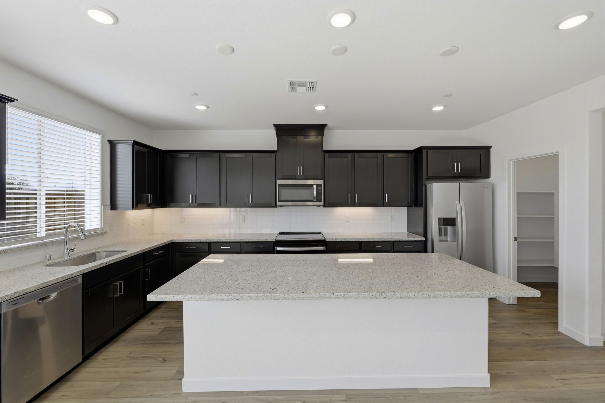 A kitchen with black cabinets.