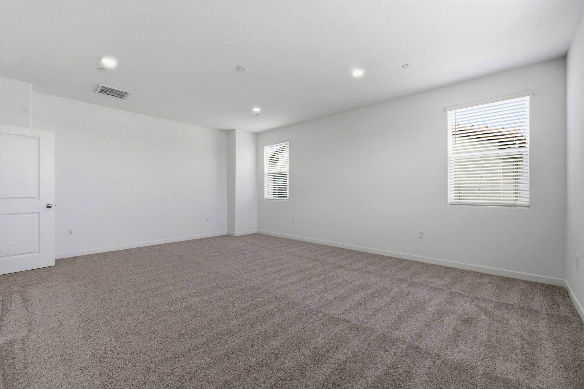 A room with a carpet and a rug.