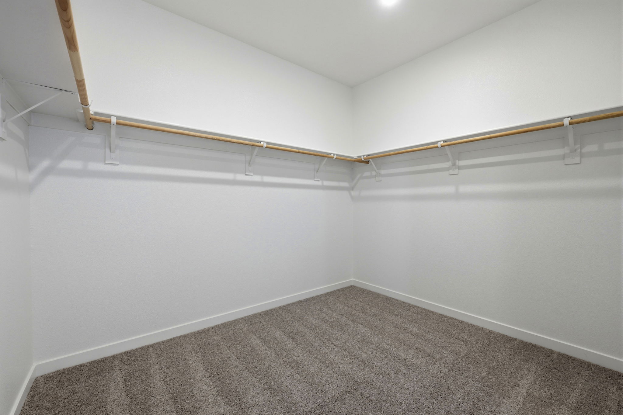 A white room with a carpet.