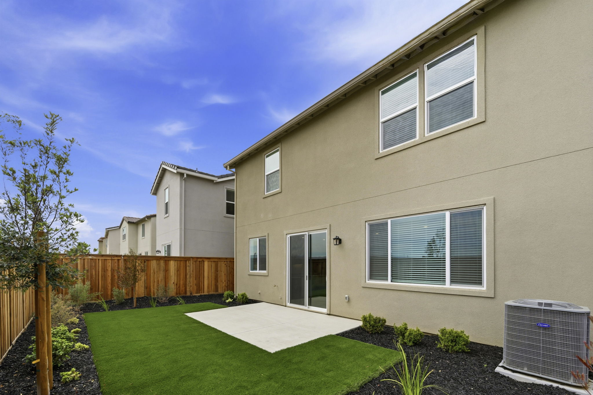 A house with a fence and yard.