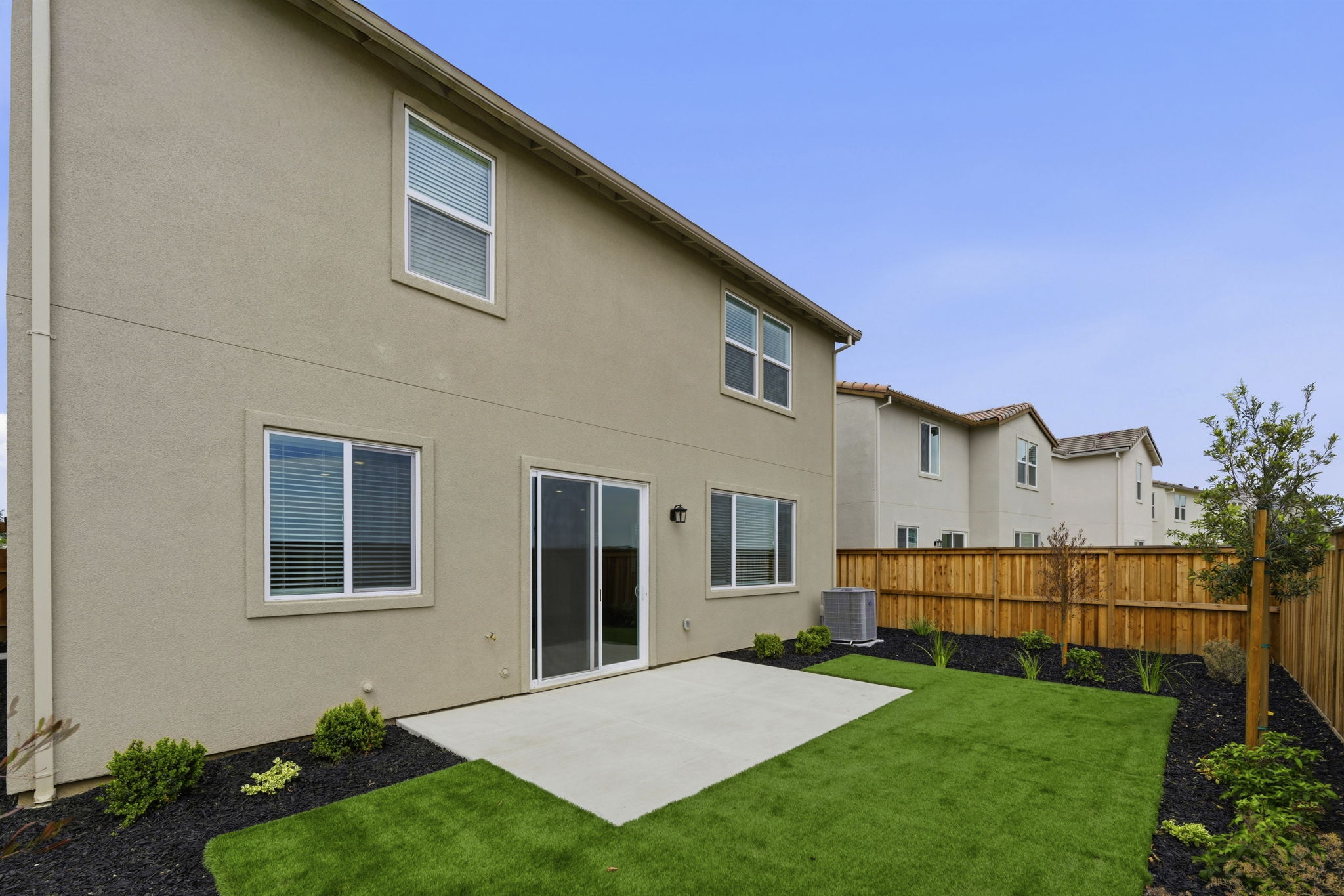 A house with a fence and yard.