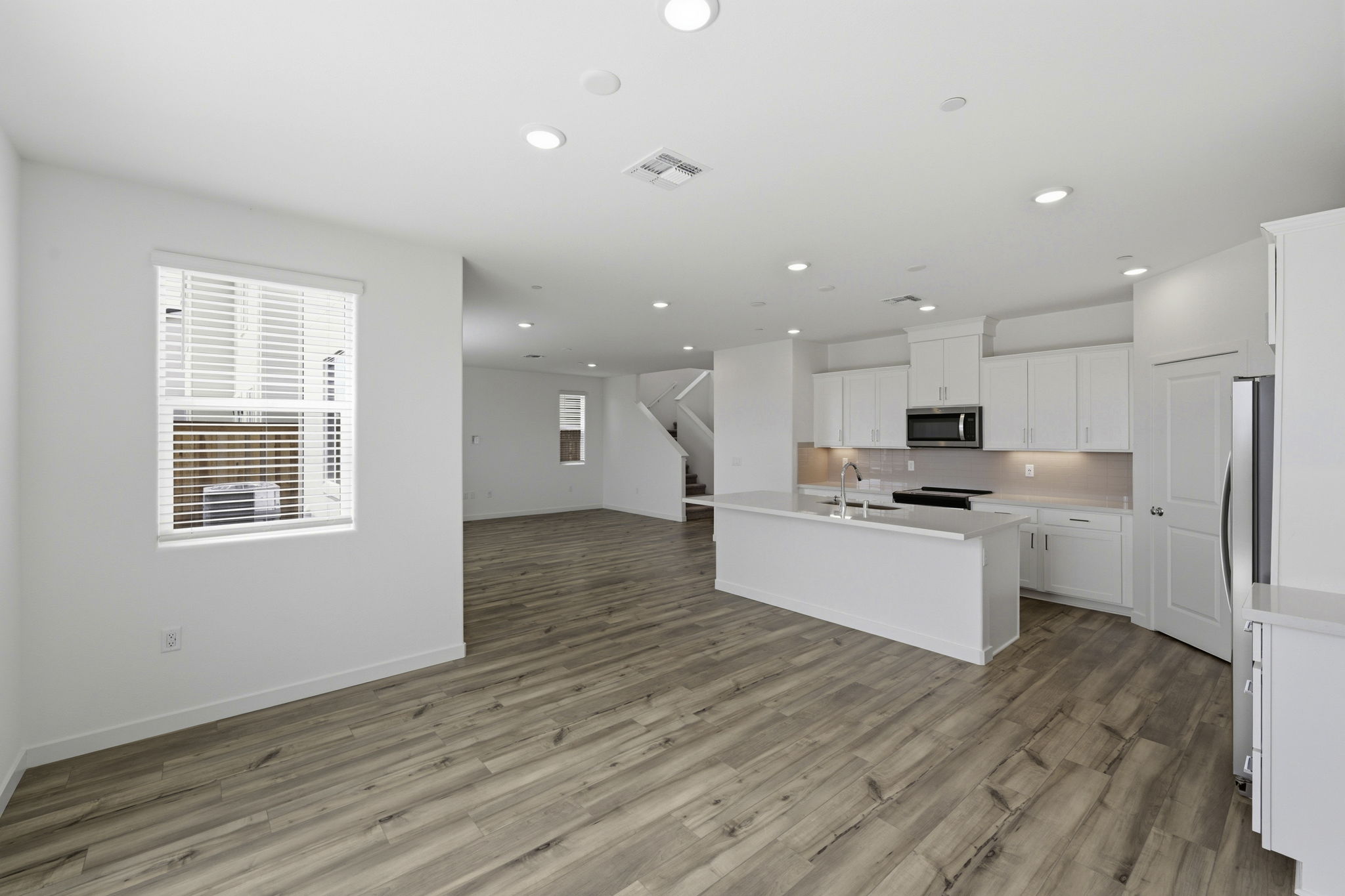 A kitchen with white cabinets.