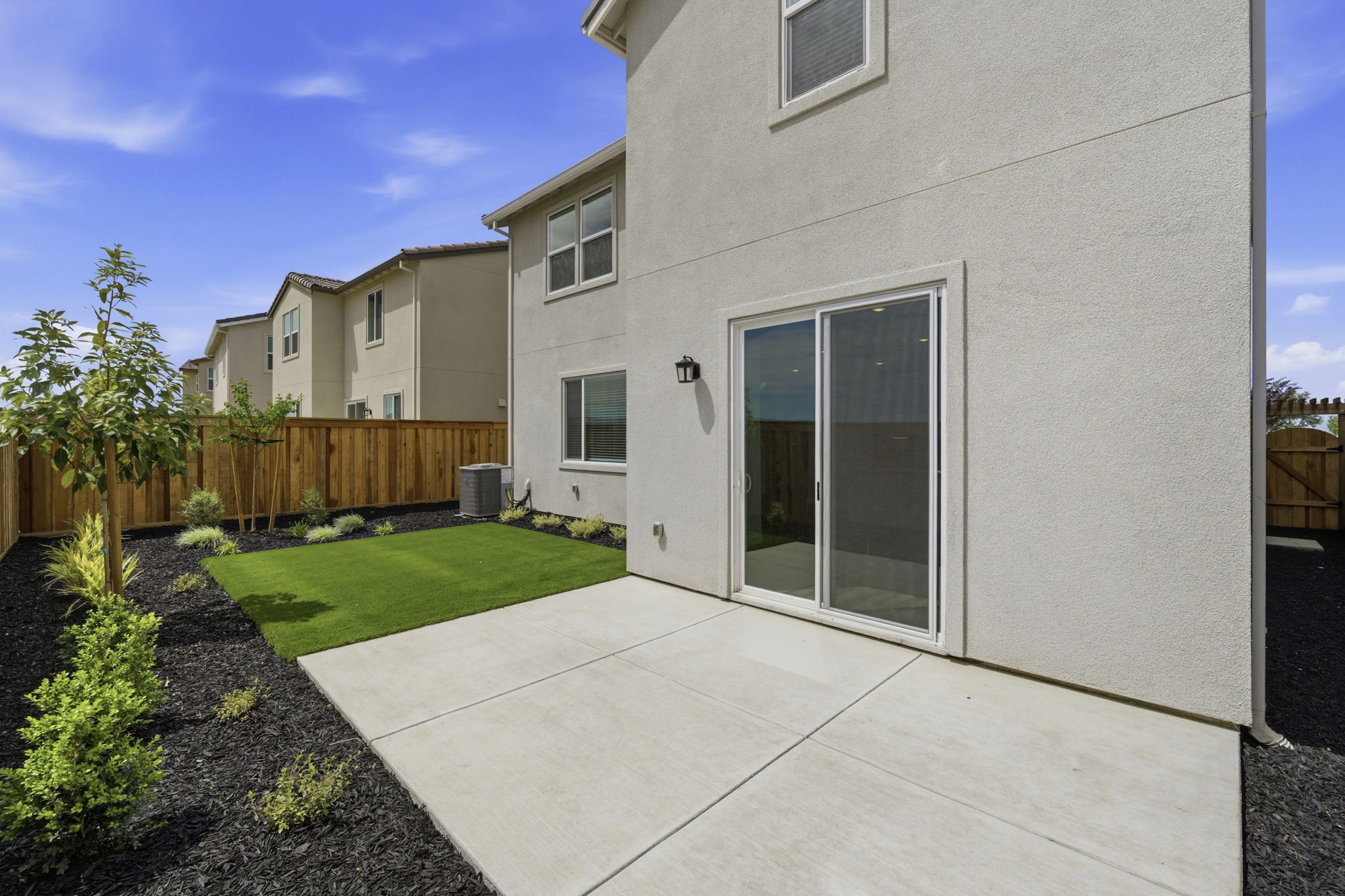 A house with a fence and grass.