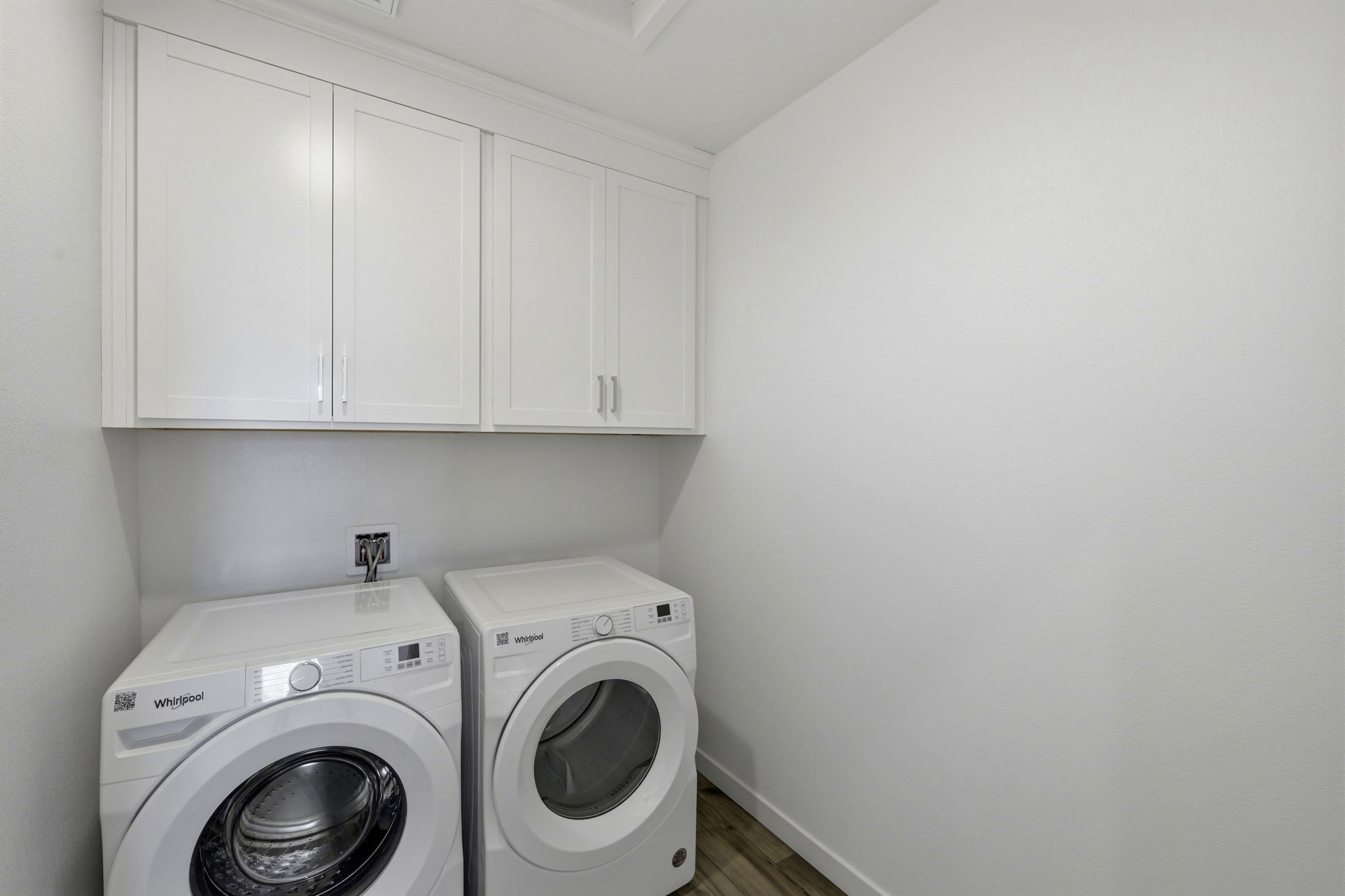 A washing machine and dryer in a room.
