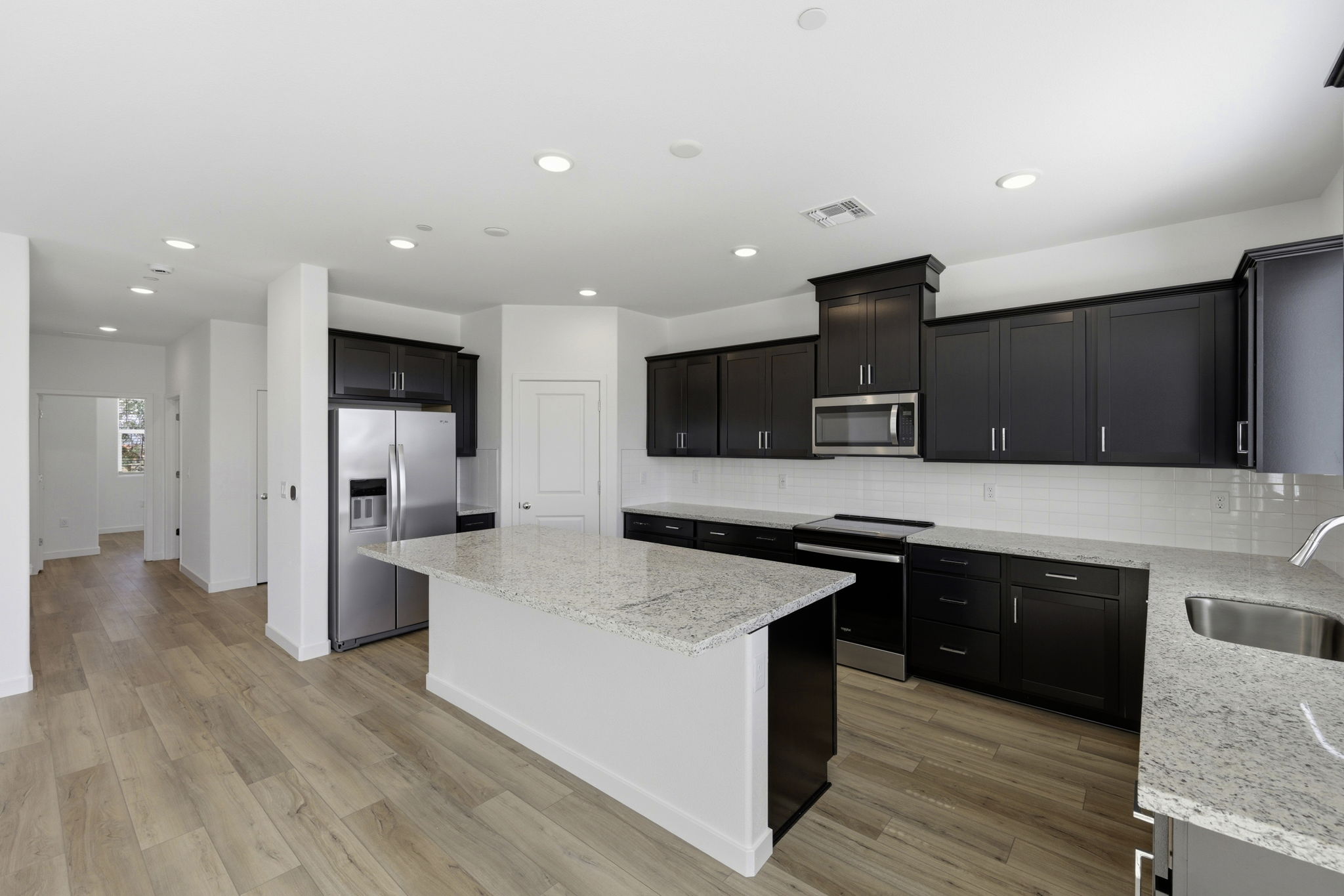 A kitchen with black cabinets.
